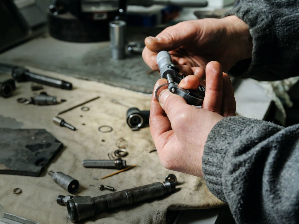 A technician inspecting and testing fuel injectors to ensure smooth engine operation.