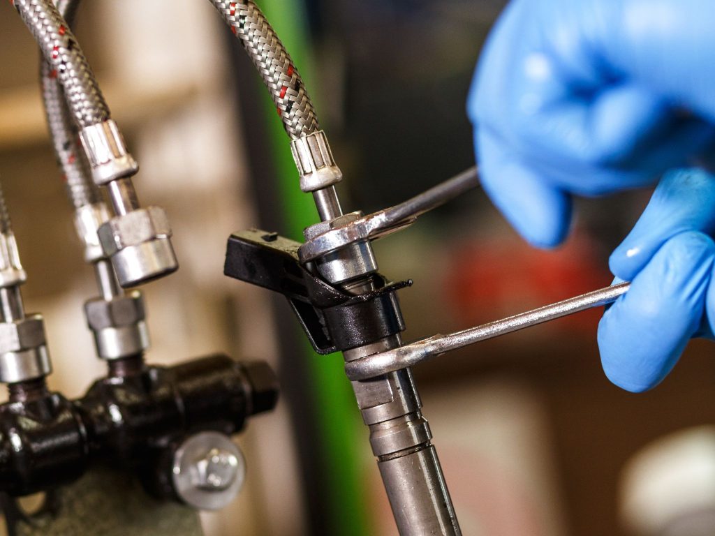 A mechanic performing diesel injector servicing in Maryborough to keep the engine running efficiently.