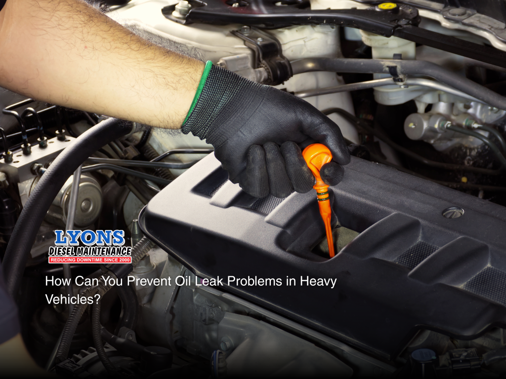 A mechanic checking oil leaks from a truck. 